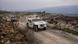 Libanon 2025 | UNIFIL-Fahrzeuge fahren neben zerstörten Gebäuden auf einer Straße Libanon 2025 | UNIFIL-Fahrzeuge fahren neben zerstörten Gebäuden auf einer Straße