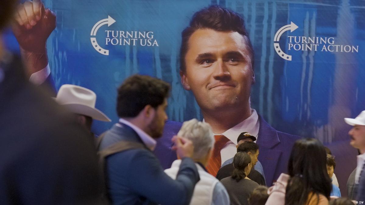 A large photo of Charlie Kirk at a Turning Point USA convention