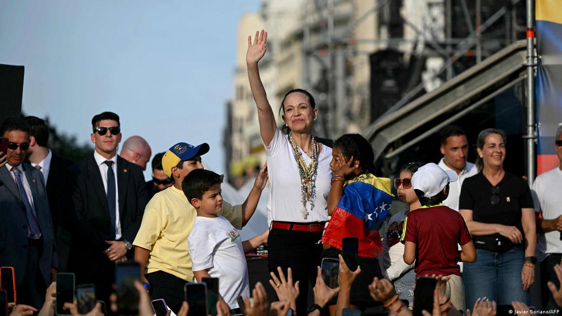 Venezuelan opposition leader Maria Corina Machado gestures on stage in front of supporters in Madrid's Puerta del Sol on April 18, 2026.