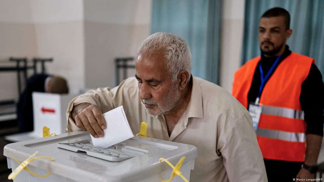 Man casting ballot in a plastic box