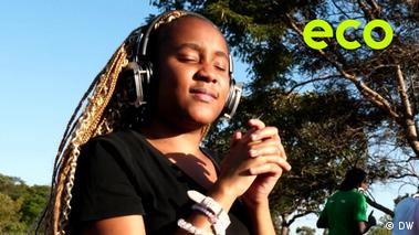 Environmental activist Hannah Mapisire dances with wireless headphones at a silent party organized by an initiative to protect the Monavale Wetland in Zimbabwe.
