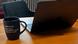 A laptop computer on a table, next to a coffee mug with a to-do-list that includes "show off AI skills" A laptop computer on a table, next to a coffee mug with a to-do-list that includes "show off AI skills"