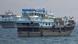 A close up photograph showing two boats in the Strait of Hormuz