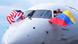 Captain Ric Wilson waves a Venezuelan flag and the first officer waves a U.S. flag as they prepare to fly American Airlines Flight AA3599 Captain Ric Wilson waves a Venezuelan flag and the first officer waves a U.S. flag as they prepare to fly American Airlines Flight AA3599