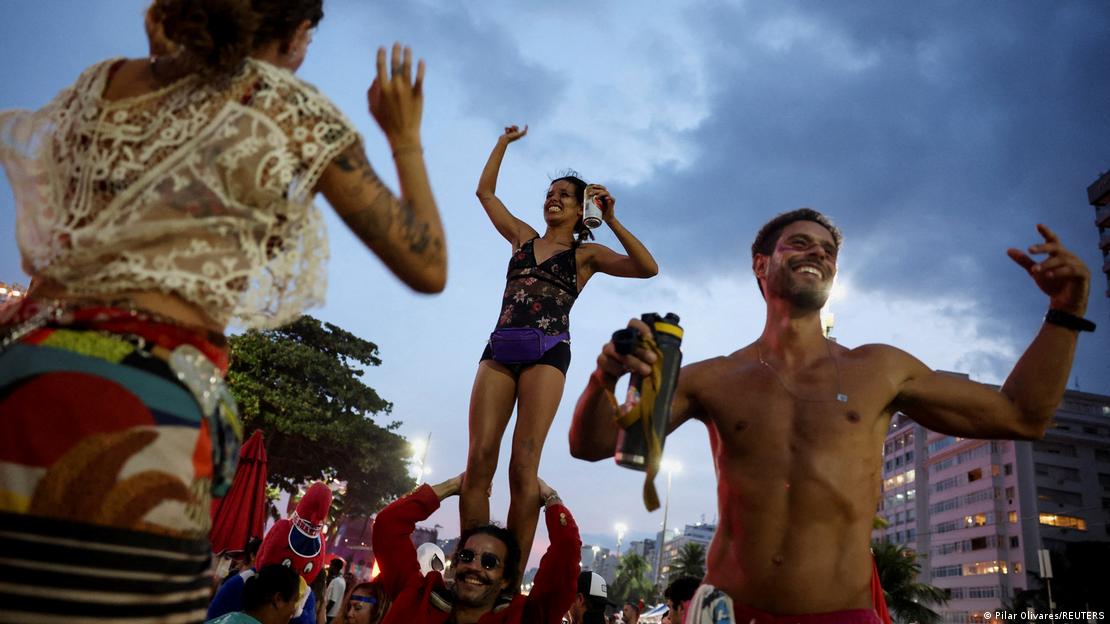 Fans dance as they gather at Copacabana beach