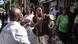 A street vendor gestures as he tries to persuade a protester of his South African citizenship during a protest march against undocumented migrants