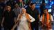 Indian Prime Minister Narendra Modi smiling, wearing an orange scarf and flanked by three men Indian Prime Minister Narendra Modi smiling, wearing an orange scarf and flanked by three men