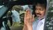 Vijay clasps his hands together while looking out of a car window Vijay clasps his hands together while looking out of a car window