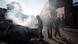 Smoke is seen rising from a burned vehicle as South African locals stand around a number of burned vehicles and buildings in Johannesburg in 2015 Smoke is seen rising from a burned vehicle as South African locals stand around a number of burned vehicles and buildings in Johannesburg in 2015
