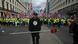 A protester walks ahead of stewards leading supporters of British far-right activist Tommy Robinson, real name Stephen Yaxley-Lennon, during a march organised by Unite The Kingdom, in central London on May 16, 2026 A protester walks ahead of stewards leading supporters of British far-right activist Tommy Robinson, real name Stephen Yaxley-Lennon, during a march organised by Unite The Kingdom, in central London on May 16, 2026