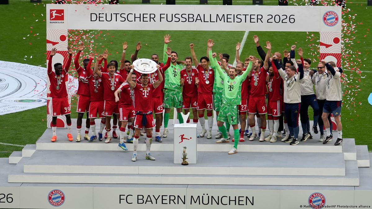 Bayern Munich hold the Bundesliga trophy aloft after winning the 2025-26 league season
