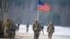 US soldiers march with their flag during the inauguration of a bilateral military training of US and Polish Forces in Poland in Jan 2017 US soldiers march with their flag during the inauguration of a bilateral military training of US and Polish Forces in Poland in Jan 2017