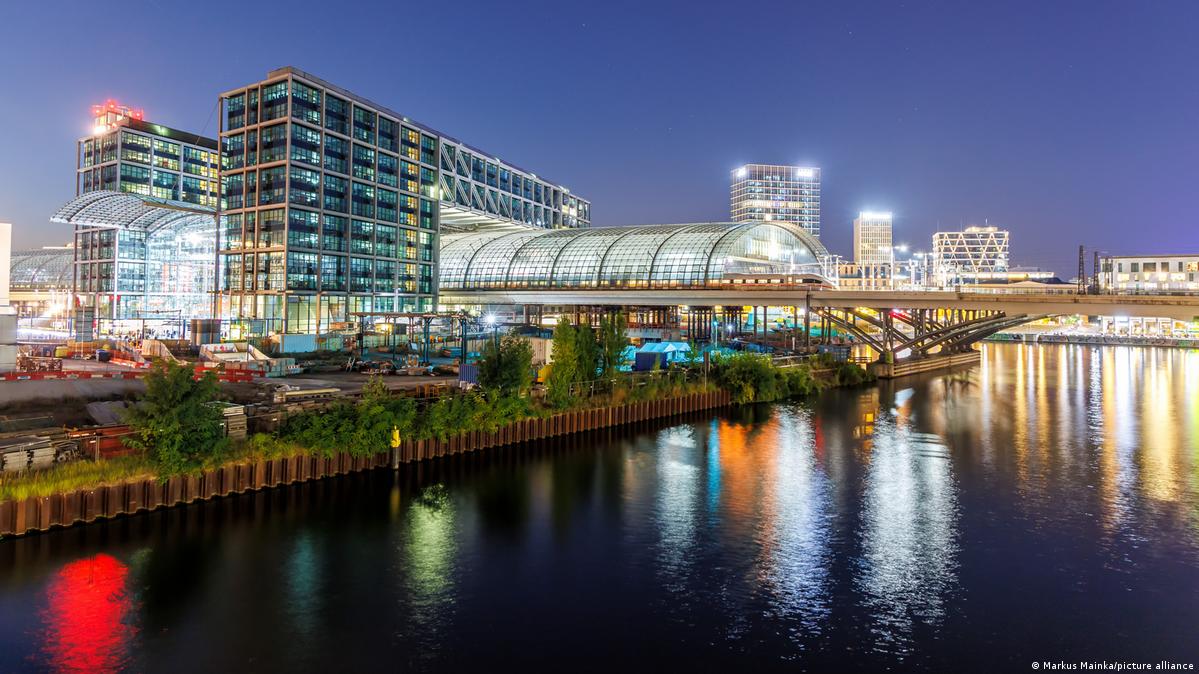 Berlin central station lit up, next to the Spree River.