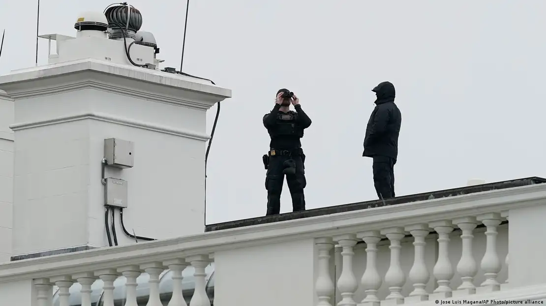  U.S. Secret Service Police observe from the roof of the White House,