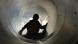 A child pictured inside a tube slide A child pictured inside a tube slide