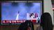 A woman watches a television screen showing a news broadcast with file footage of a North Korean missile test, at a train station in Seoul on May 26, 2026. A woman watches a television screen showing a news broadcast with file footage of a North Korean missile test, at a train station in Seoul on May 26, 2026.
