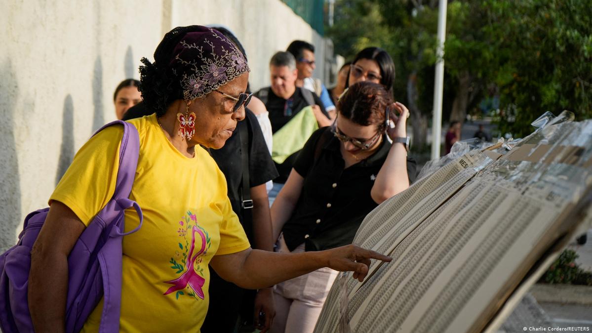 A woman checks an election voter lists posted outside a polling station during the first round of the presidential election, in Barranquilla, Colombia May 31, 2026