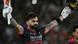 Virat Kohli holds a cricket bat and helmet aloft with outstretched arms Virat Kohli holds a cricket bat and helmet aloft with outstretched arms