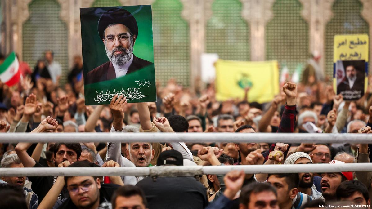 A man holds a placard with an image of Iran's Supreme Leader Mojtaba Khamenei during a ceremony for the 37th anniversary of the death of Ayatollah Ruhollah Khomeini, the leader of Iran's 1979 Islamic