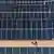 A worker walks past rows of panels at a newly opened industrial-scale solar power plant in Karbala, Iraq, Wednesday, Sept. 17, 2025. Seen from above