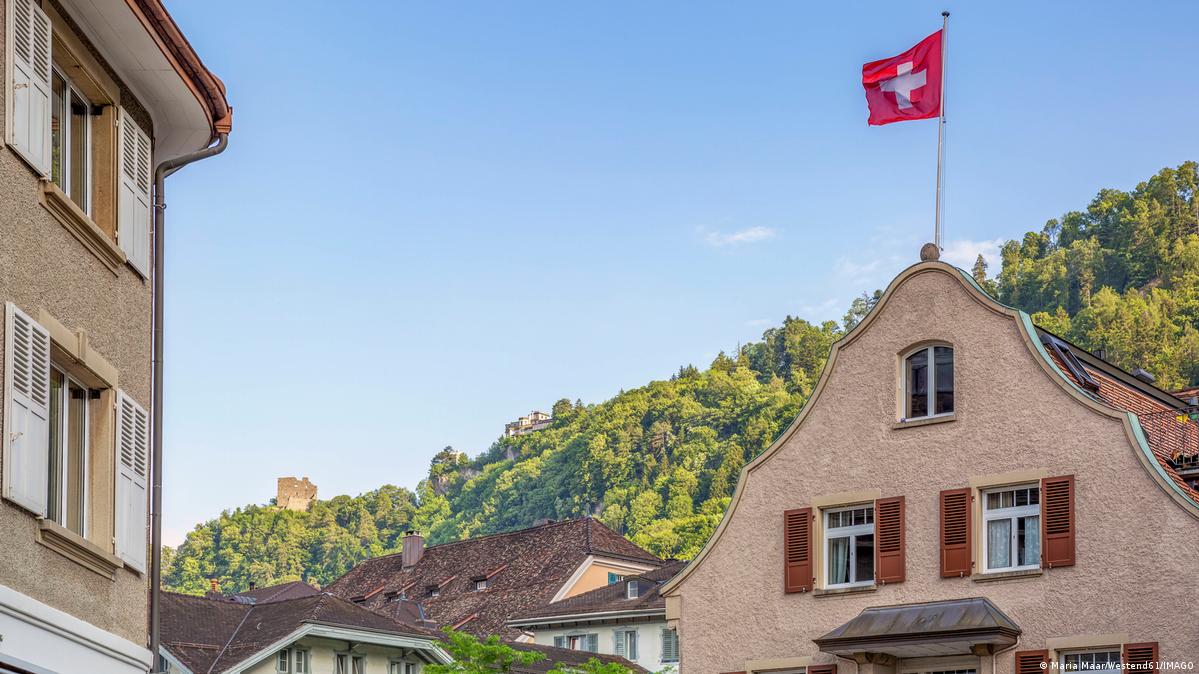 A house with a Swiss flag against a blue sky