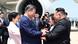 Xi Jinping and Kim Jong Un shake hands in front of an airplane Xi Jinping and Kim Jong Un shake hands in front of an airplane