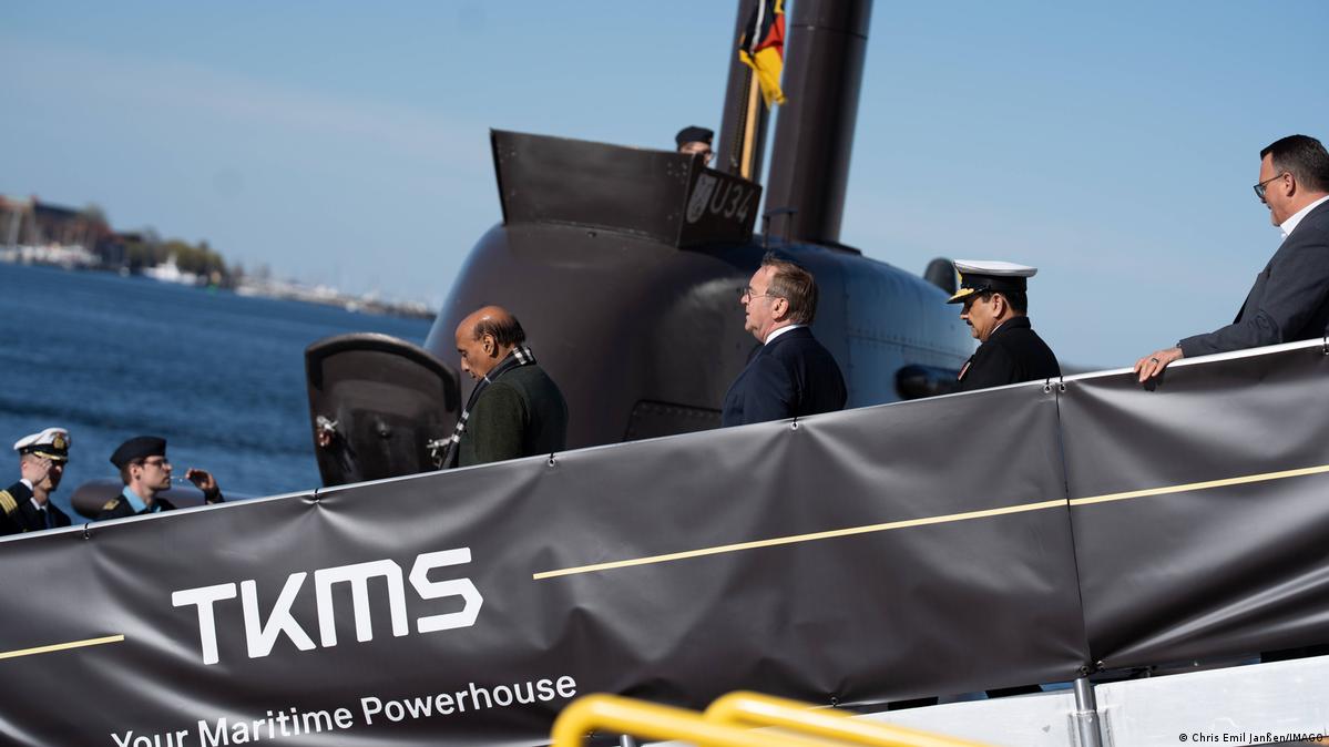 India’s and Germany’s defense ministers enter a submarine via a gangway, a submarine is visible in the background