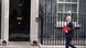 John Healey holding a red folder and walking toward the door of 10 Downing Street John Healey holding a red folder and walking toward the door of 10 Downing Street