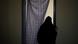 A woman wearing a burqa - with her back facing us A woman wearing a burqa - with her back facing us