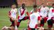 Several young men doing kneeling stretches Several young men doing kneeling stretches
