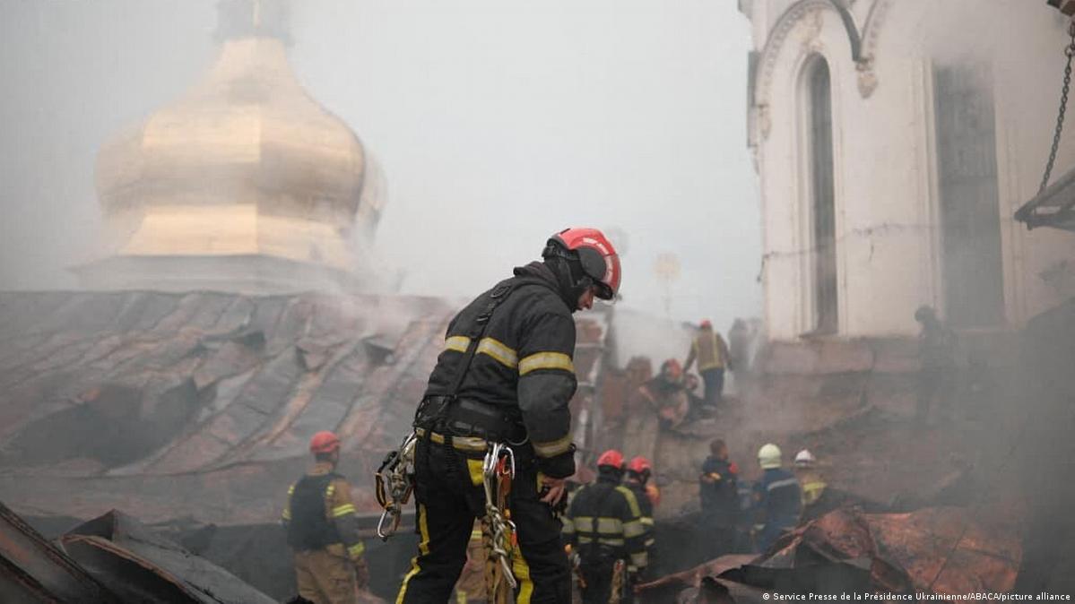 Ukrainian rescue workers on the smokey roof of Kyiv's Assumption Cathedral following a Russian drone strike