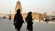 Tunisian salafi women in black hijabs walk in front of Okba Ibn Nafaa mosque in the city of Kairouan Tunisian salafi women in black hijabs walk in front of Okba Ibn Nafaa mosque in the city of Kairouan