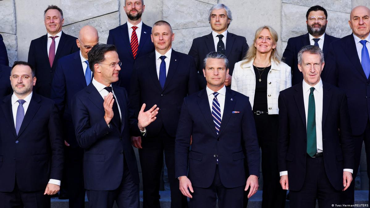 NATO Secretary General Mark Rutte (center left) claps while looking at US Secretary of Defense Pete Hegseth (center) in a photo of NATO defense ministers in Brussels on June 18, 2026