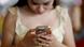 Elegant girl with manicured nails holds premium phone Elegant girl with manicured nails holds premium phone