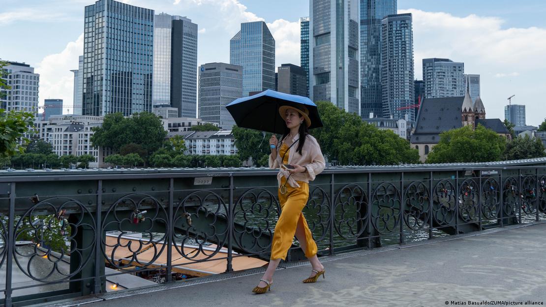 A woman protects herself from the heat in Frankfurt A woman protects herself from the heat in Frankfurt