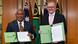 Vanuatu Prime Minister Jotham Napat and Australian Prime Minister Anthony Albanese holding up folders with the agreement Vanuatu Prime Minister Jotham Napat and Australian Prime Minister Anthony Albanese holding up folders with the agreement