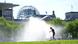 A woman runs through a fountain in Berlin A woman runs through a fountain in Berlin