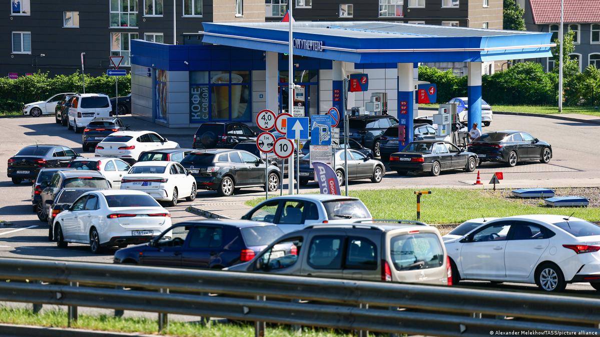 About 20 cars queue in front of a gas station