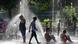 People cool off under water jets in Madrid People cool off under water jets in Madrid