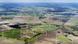 An aerial view of a wind turbines standing in fields An aerial view of a wind turbines standing in fields