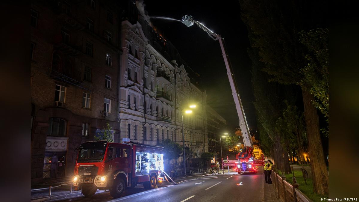 Emergency services at the site of a strike on a residential building during a night of Russian missile and drone strikes on Kyiv
