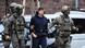 Serhii K. is escorted in handcuffs by armed German police officers Serhii K. is escorted in handcuffs by armed German police officers