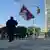 A man identified by Voice of Tibet, a media outlet of exiled Tibetans, as Tibetan activist Lobga Rangzen, walks carrying a Tibetan flag near the United Nations headquarters, before setting himself on fire