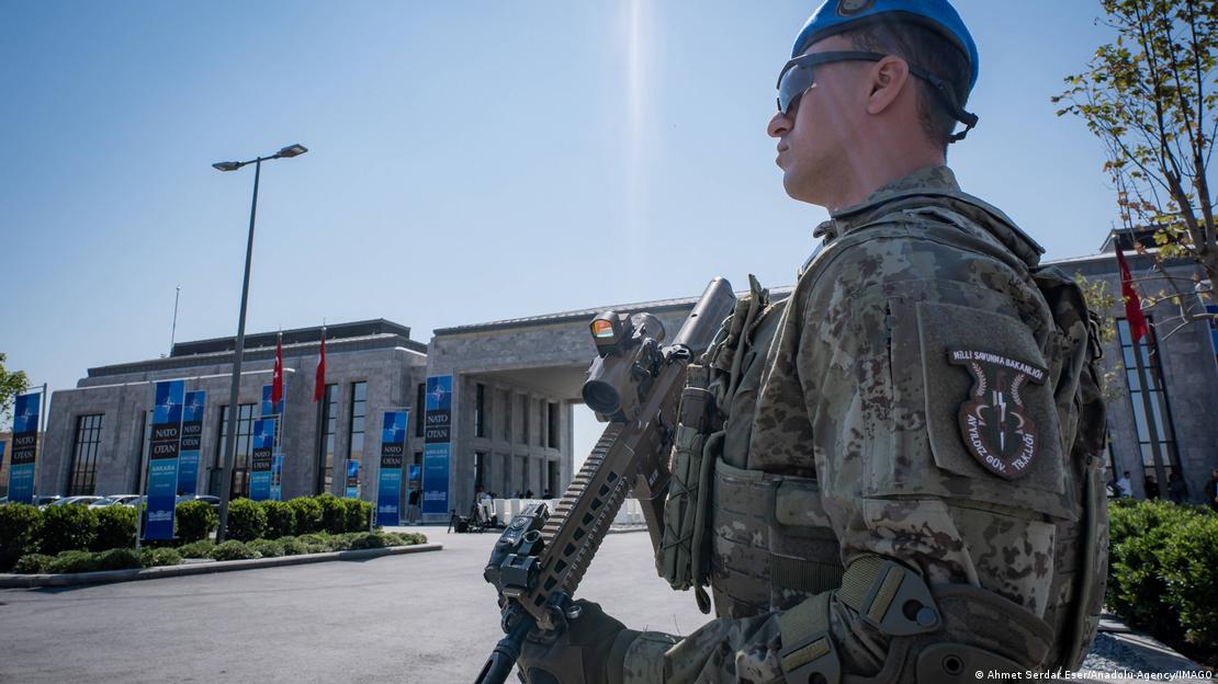 NATO zirvesinin yapılacağı bölgede silahıyla görev yapan bir güvenlik görevlisi.