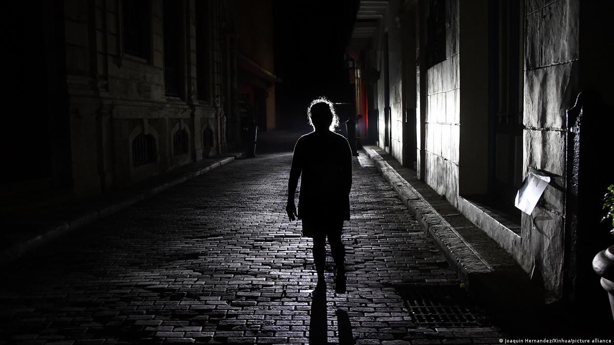 Pedestrian warks in dark street in Havana, Cuba during nationwide blackout