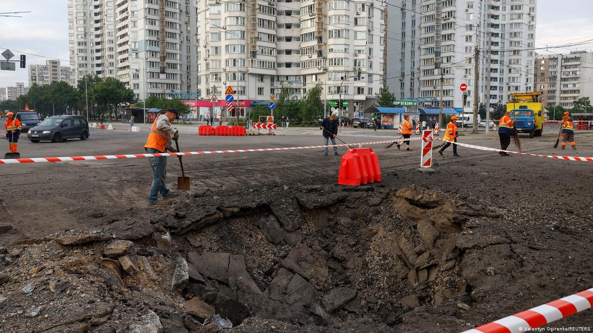 Municipal employees remove debris next to a crater that appeared after Russian missile strikes, amid Russia's attack on Ukraine, in Kyiv, Ukraine July 11, 2026.