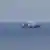 A vessel pictured on fire amid reports from Ukraine that 11 Russian vessels were struck in the Sea of Azov