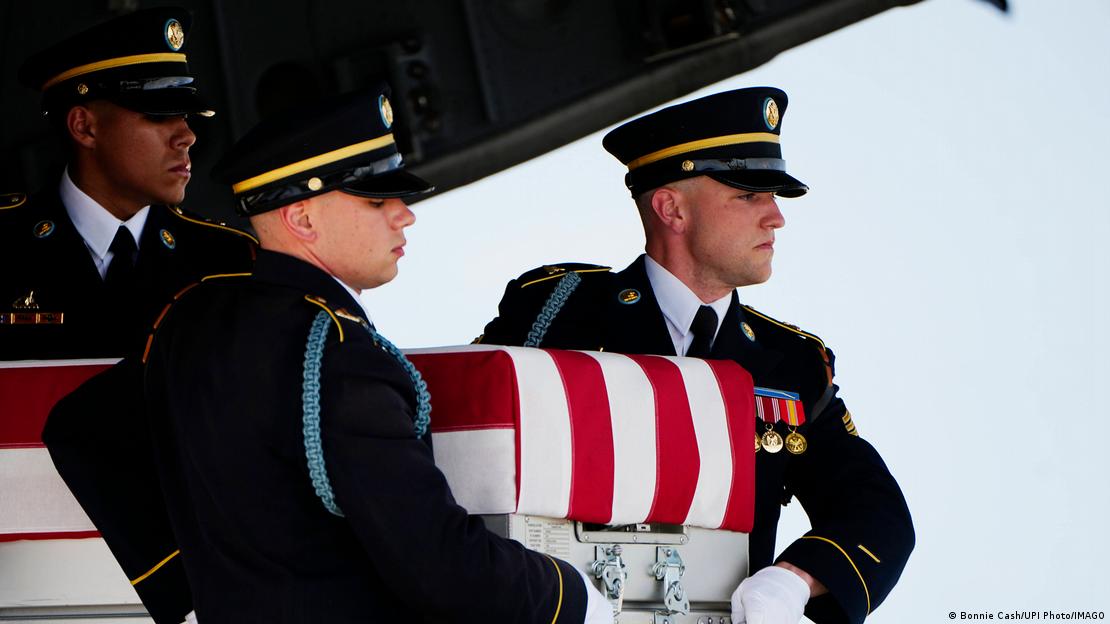 Bir Amerikan askerinin bayrağa sarılı tabutunu taşıyan 3 asker