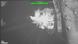 Grainy black-and-white aerial photo of an explosion on a ship beside a dock. The image has UNCLASSIFIED written in green across the top.