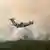 This photograph taken from the French Civil Security rescue coordination helicopter shows a French Air Force military transport A400M aircraft flying during its first-ever drop of fire retardant over the wildfire near Lacanau, southwestern France, on July 25, 2026